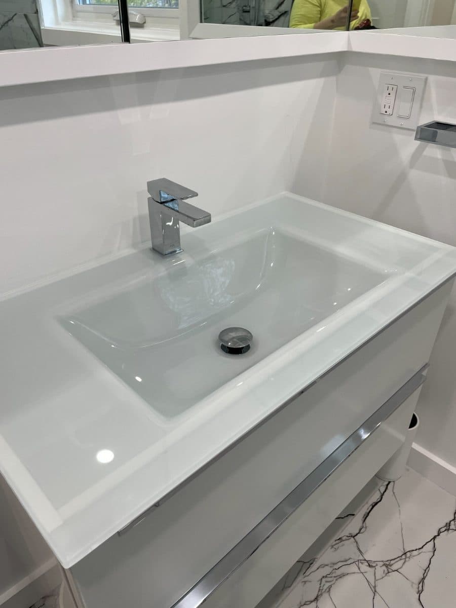 Wall-hung vanity with an integrated basin and single-lever chrome mixer.